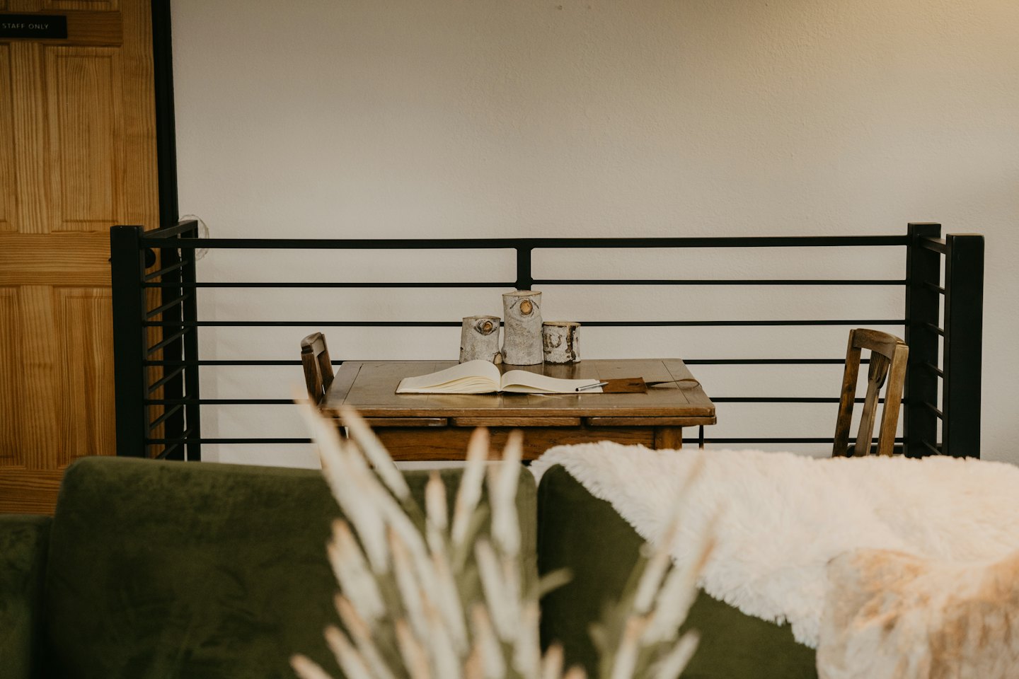 Open notebook and pen resting on a rustic wooden table.